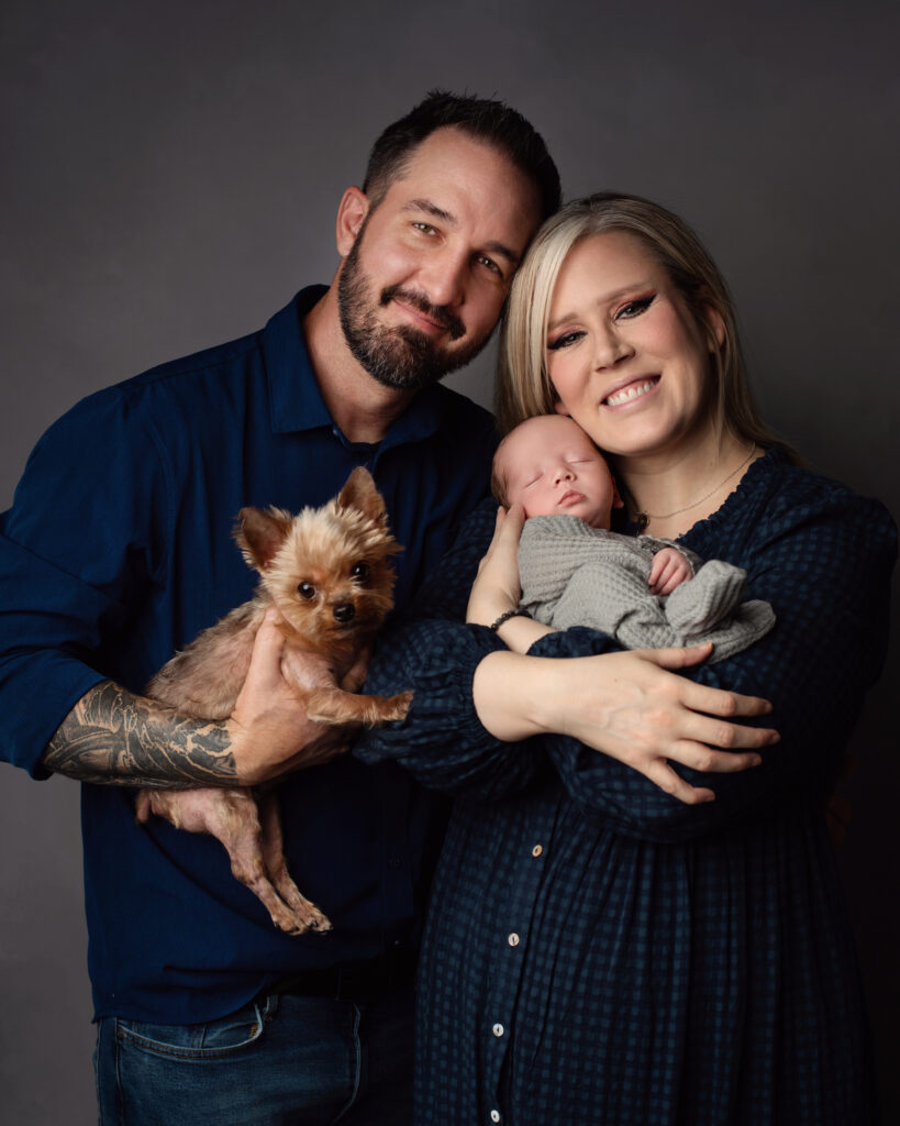 baby photoshoot with yorkie and family posed newborn photos professional photos by a Utah county photographer