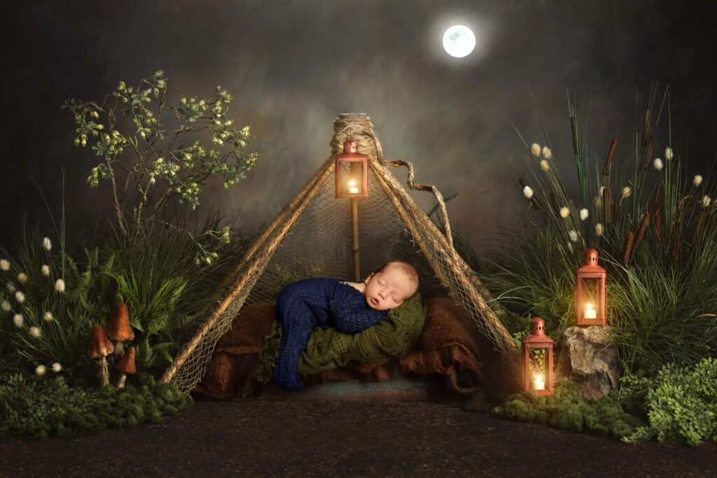 Baby photoshoot camping backdrop with baby asleep underneath a moon with lanterns in Utah County