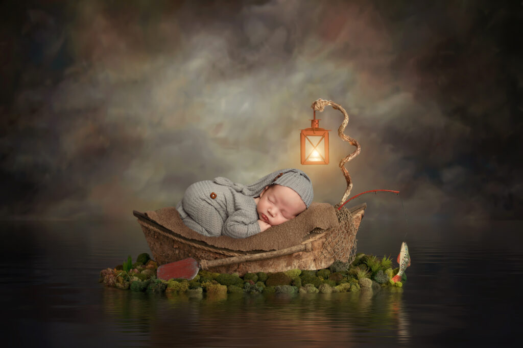 beautiful baby sleeping on a boat for a photoshoot newborn photography